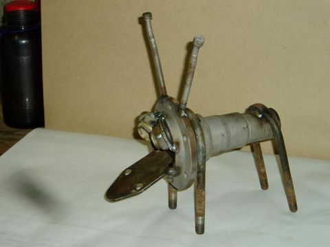 2000 Ford E350 - A sculpture crafted from various metal components, including a hub and bolts, is displayed on a surface.