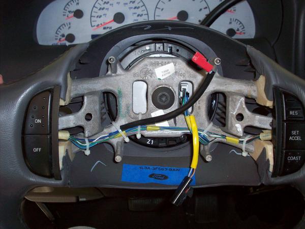 Steering wheel interior with exposed wiring and Ford logo
