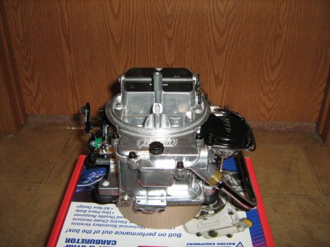 1988 Mercury Grand Marquis - A Holley carburetor is shown on top of its product box.