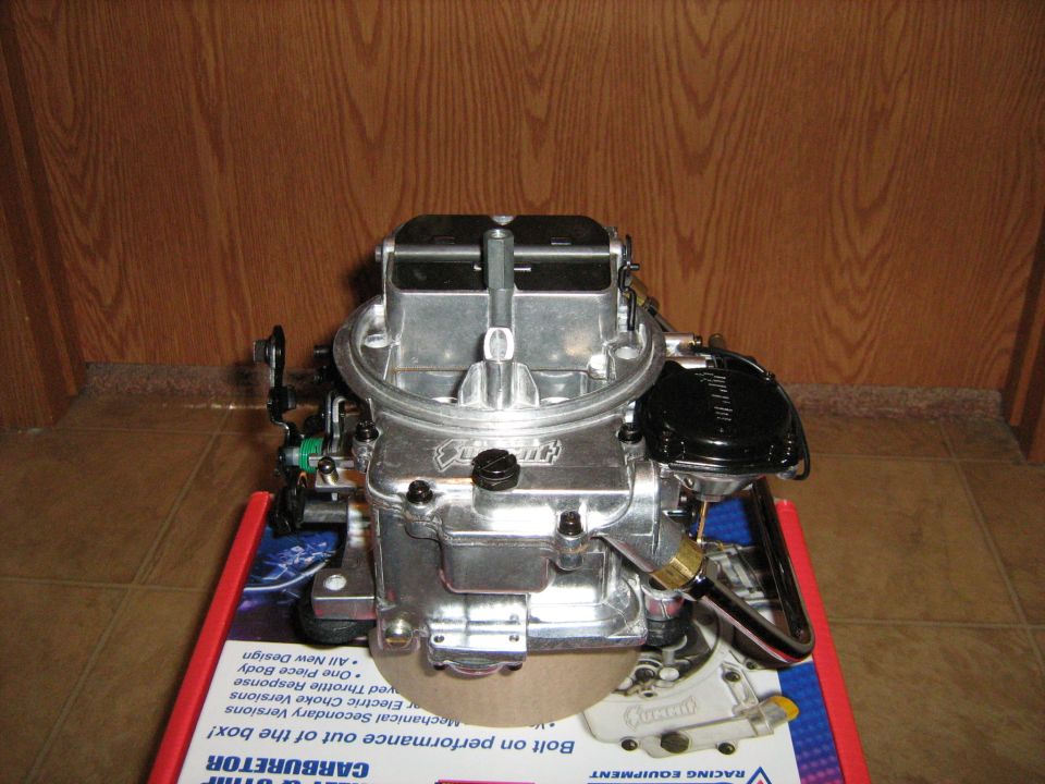 Holley carburetor sitting on a box with text about performance and carburetors