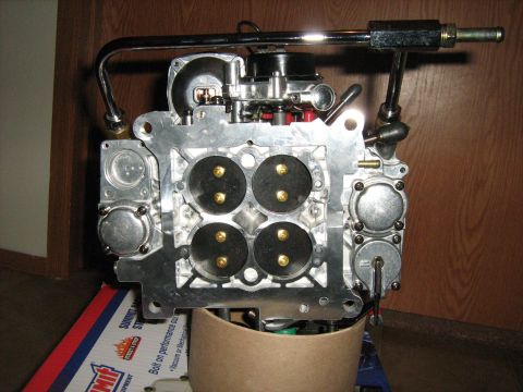 1988 Mercury Grand Marquis - A close-up view of a carburetor, a critical engine component for fuel delivery.