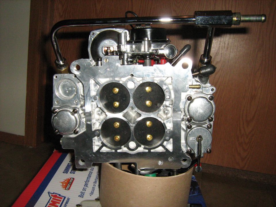 Carburetor with four circular openings and brass screws