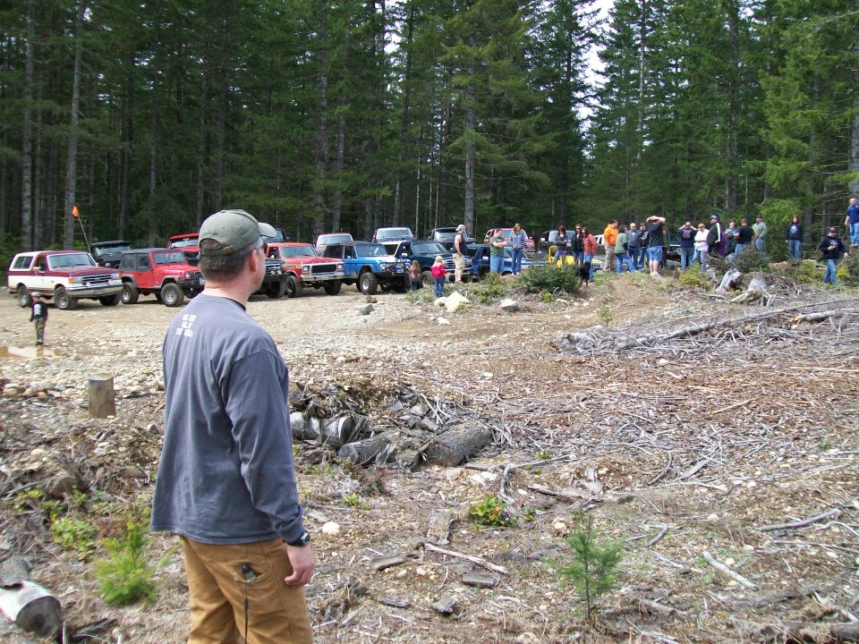 1991 Ford Bronco parked with other off-road vehicles and people gathered