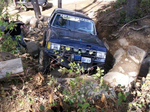 1991 Ford Bronco - This 1991 Ford Bronco tackles a challenging rocky path, demonstrating its off-road capabilities. Another vehicle is visible in the backgrou…