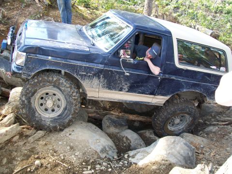 1991 Ford Bronco - This 1991 Ford Bronco tackles a challenging off-road obstacle course with large rocks and logs.