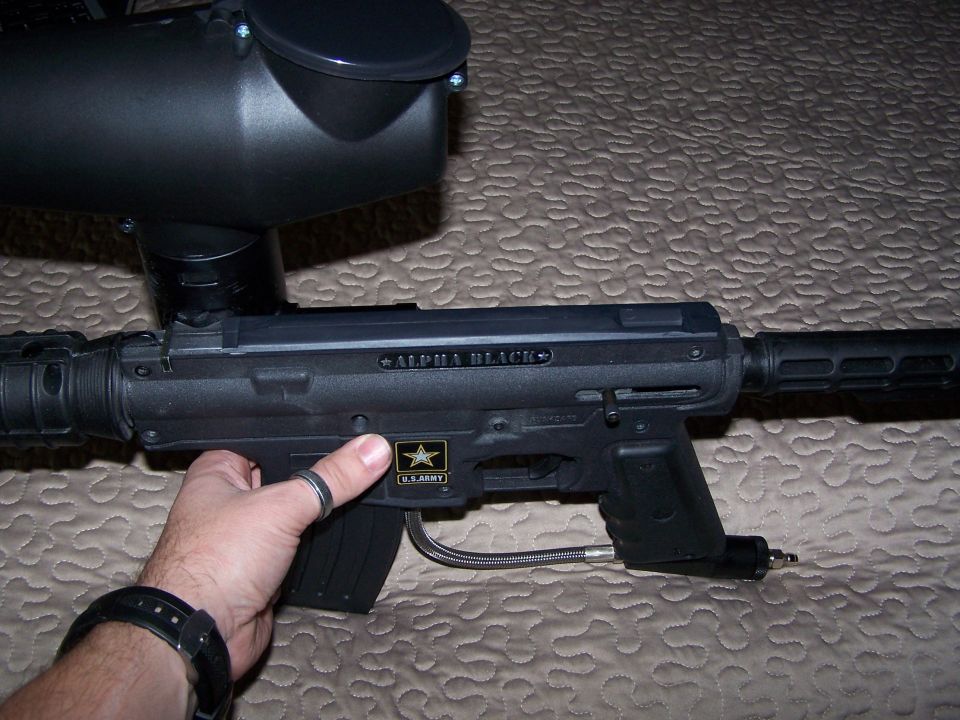 Black paintball gun with "ALPHA BLACK" text and U.S. Army logo