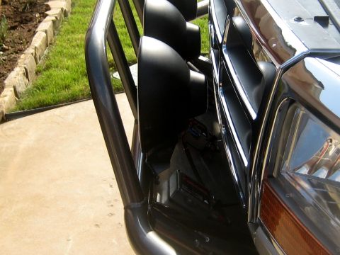 1996 Ford Bronco - Close-up of a 1992 Ford Bronco's front end, showing a bull bar, auxiliary lights, and chrome grille.