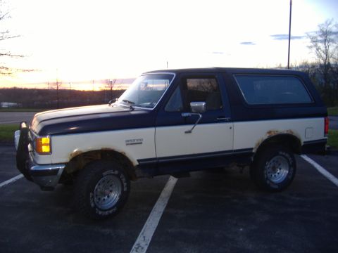 1988 Ford Bronco - This two-tone Ford Bronco shows rust on the rear fender, indicating its age.