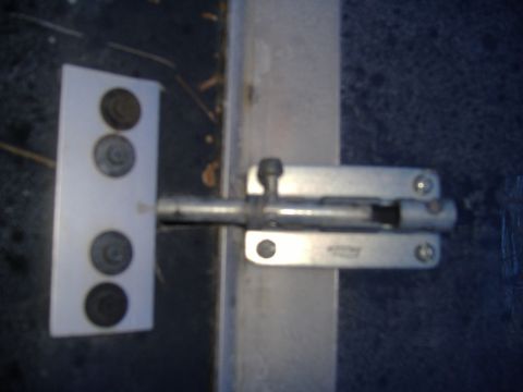 1988 Ford Bronco - Close-up of a metal door bolt latch mechanism.