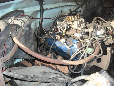 1982 Ford Bronco - Close-up view of an engine bay, a blue engine block and carburetor.