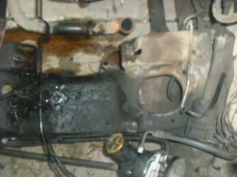 1982 Ford Bronco - Underside view of a vehicle's frame, showing engine components and signs of wear and tear.