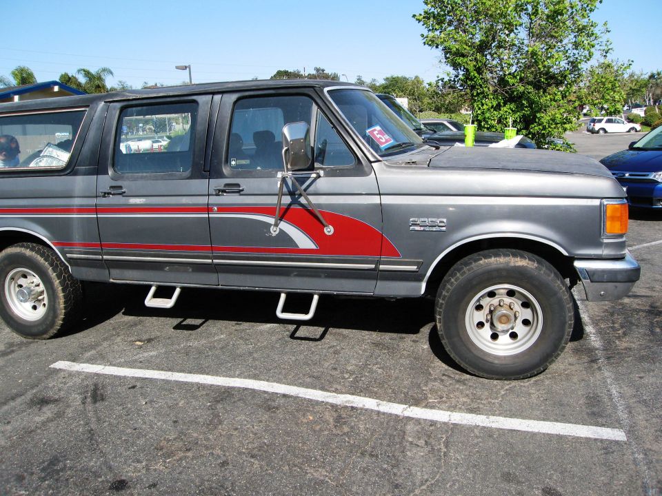 Gray Ford F-Series SUV with red stripe detail, parked in a lot