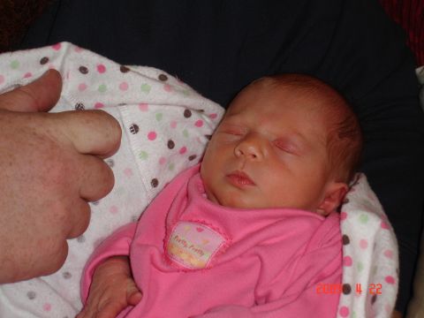 1996 Ford Bronco - A newborn baby sleeps peacefully in a pink outfit, swaddled in a polka-dot blanket.