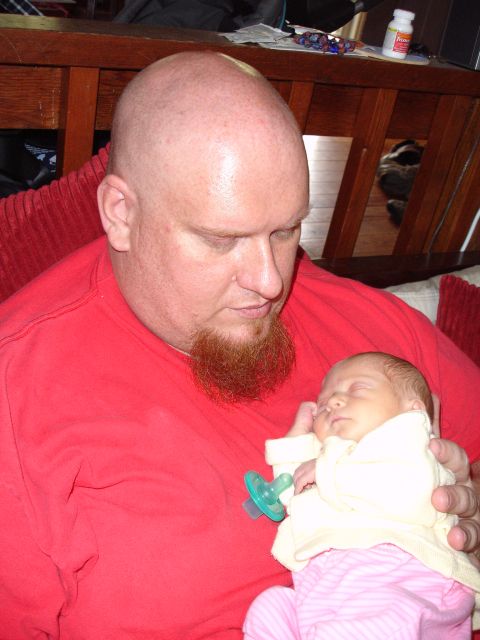 1996 Ford Bronco - A man holds a newborn baby, who is sleeping with a pacifier.