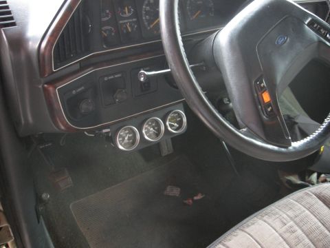 1990 Ford F-150 - The interior of a 1990 Ford F-150 shows a dashboard with added gauges below the main instrument panel.