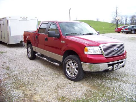 2008 Ford F-150 - 2008 Ford F-150 pickup truck is shown from the front-three-quarter view, towing a trailer.