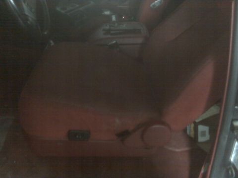 1995 Ford Bronco - The interior of the vehicle shows the passenger seat and part of the center console.