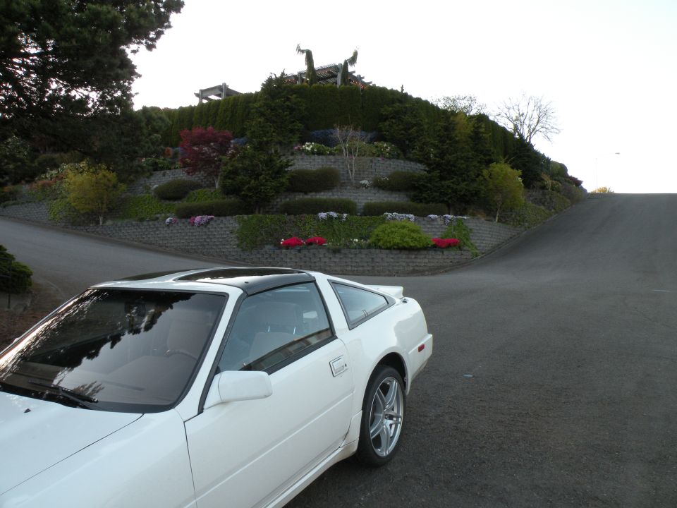 White 1989 Nissan 300ZX coupe with black T-top roof parked on a road.