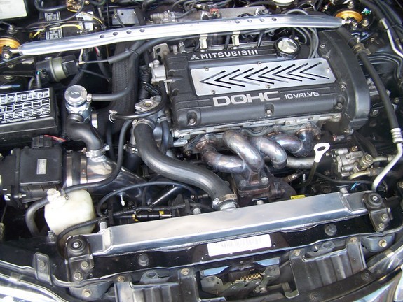 1997 Mitsubishi Eclipse GSX engine bay with DOHC 16 valve engine, polished radiator, and blow-off valve.