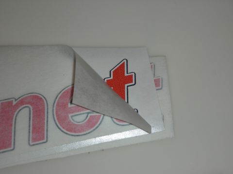 1998 Ford Crown Victoria - Photograph of stacked vinyl lettering decals with backing partly removed.