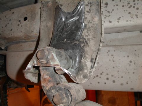 1990 Chevrolet Suburban - A close-up view of a heavily modified suspension component on the underside of a vehicle, likely a Chevrolet Suburban, showing significant…