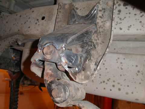1990 Chevrolet Suburban - A close-up view of a custom-welded suspension bracket attached to the frame of a vehicle. The bracket is heavily welded and appears to be a…