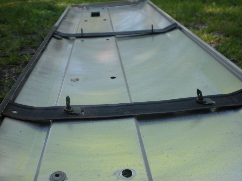Underside of a metal panel with rubber seal and clips