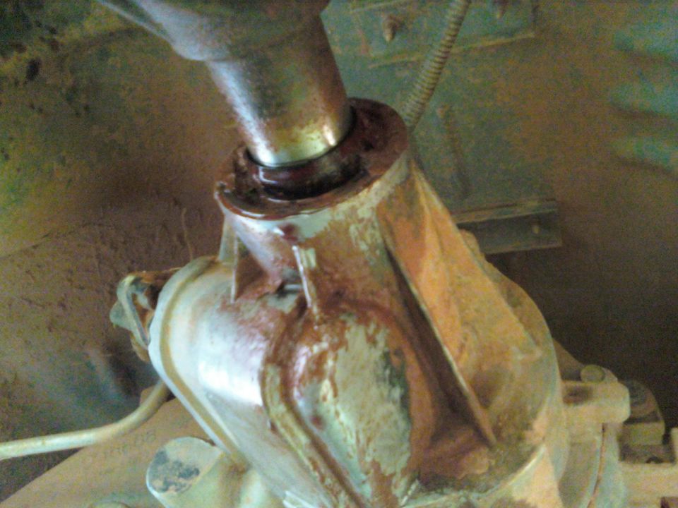 Rusty driveshaft yoke connected to differential housing.