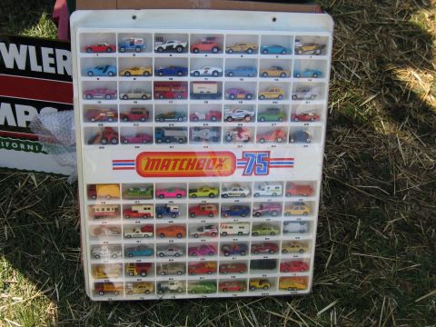 2001 Ford Crown Victoria - Photo of a Matchbox 75 die-cast car display case at a swap meet, not a technical document.