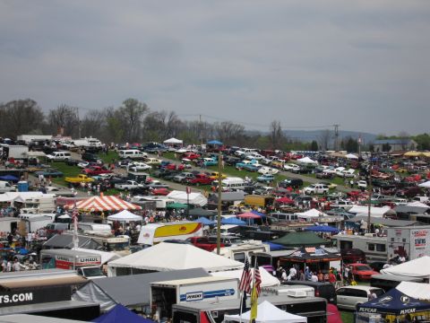 2001 Ford Crown Victoria - A vast outdoor gathering of vehicles and vendors, suggesting a car show or swap meet.