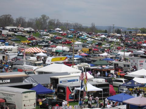 2001 Ford Crown Victoria - A large outdoor gathering of cars and vendors, likely a car show or swap meet.
