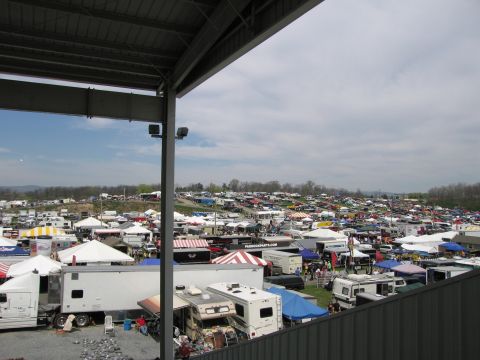 2001 Ford Crown Victoria - A vast outdoor gathering of vehicles and vendors under a cloudy sky.