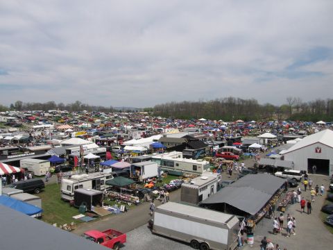 2001 Ford Crown Victoria - A vast outdoor market is filled with vehicles, RVs, trailers, and vendor stalls, suggesting a large automotive swap meet or flea market.