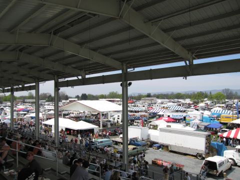 2001 Ford Crown Victoria - A wide view of a busy outdoor swap meet with spectators and vendors under tents.