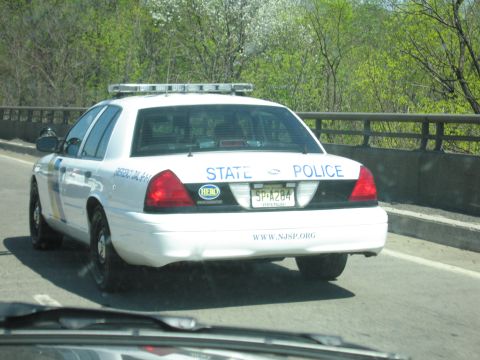 2001 Ford Crown Victoria - Photo of a New Jersey State Police cruiser on the road, not a technical document.