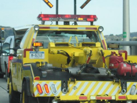 2001 Ford Crown Victoria - Photo of a yellow heavy-duty wrecker's rear deck and tow equipment, not a technical document.
