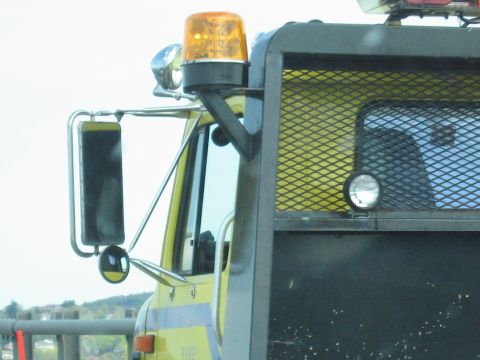 2001 Ford Crown Victoria - Detail of a truck cab, showing the side mirror and a portion of the vehicle's body.