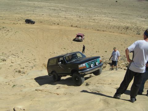 1993 Ford Bronco - A group of vehicles are off-roading in a desert landscape.