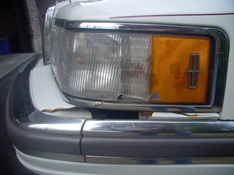 1990 Lincoln Town Car - Then the only other fastener is the philips screw down the black strip at the rear, level with the Lincoln emblem.