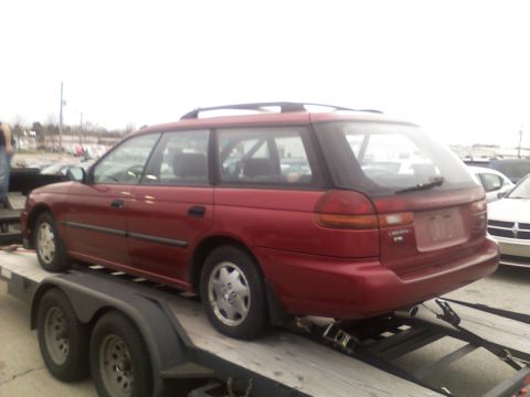 1998 Subaru Legacy - This red Subaru Legacy wagon is being transported on a trailer.