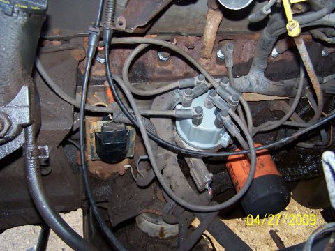 1989 Ford F-150 - Close-up view of an engine's distributor cap, spark plug wires, and an oil filter, with a date stamp of 04/27/2009.