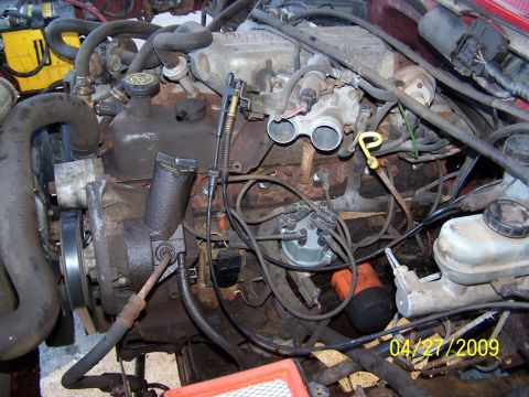 1989 Ford F-150 - Close-up view of an engine bay showing various components and wiring.