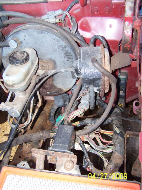 1989 Ford F-150 - The brake booster and master cylinder assembly with a complex wiring harness is visible in this engine bay shot.