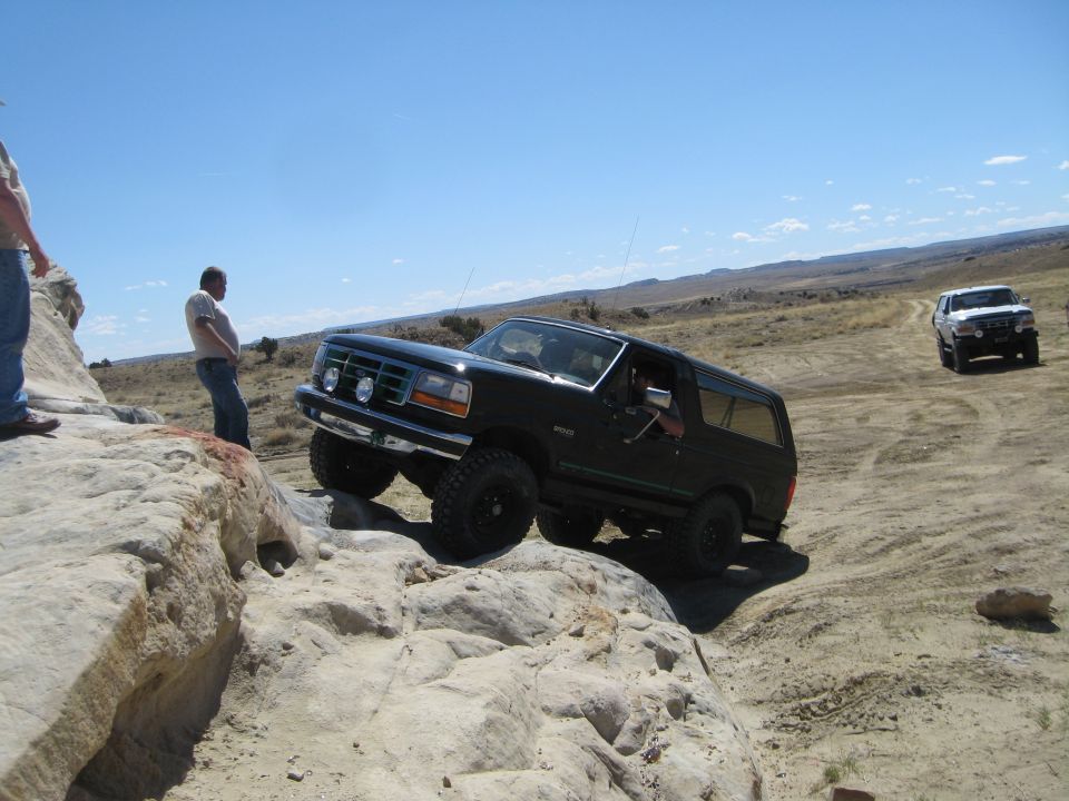 Black 1993 Ford Bronco navigating rocky terrain