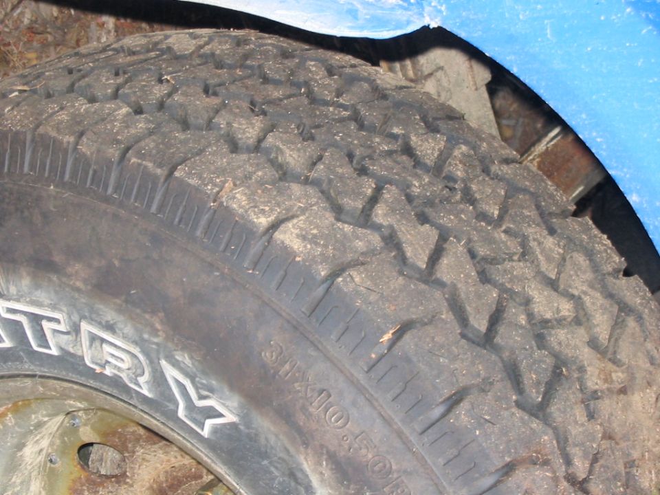 Close-up of a tire with "COUNTRY" visible on the sidewall