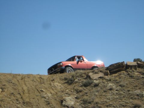 1993 Ford Bronco - This 1993 Ford Bronco navigates a steep, rocky incline under a clear blue sky.