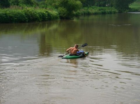 1978 Ford Bronco - Man paddles kayak on river. Supermotors.net logo visible in lower right corner.
