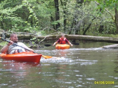 1977 Ford F-100 - Kayaking down a tree-lined river with a friend.