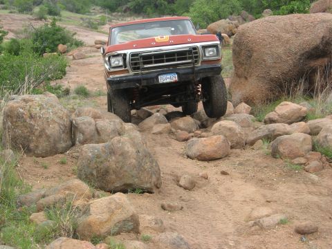 1979 Ford Bronco - This 1979 Ford Bronco is shown tackling a challenging off-road course with large boulders.