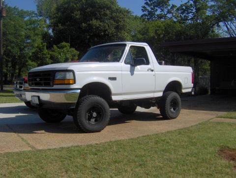 1995 Ford Bronco - White 1995 Ford Bronco with aftermarket wheels and lift kit.